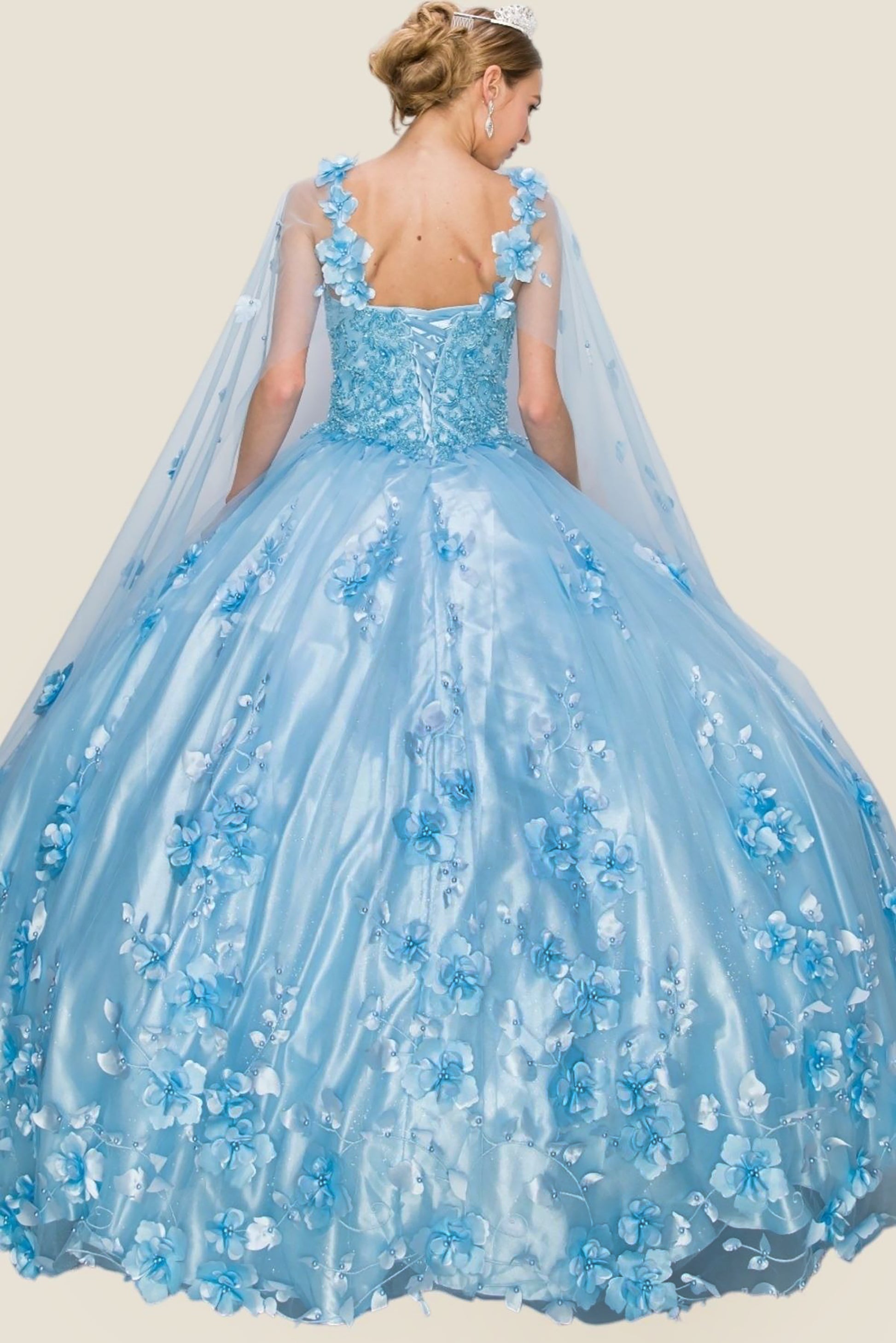 Blue floral ball gown with cape on a plain background