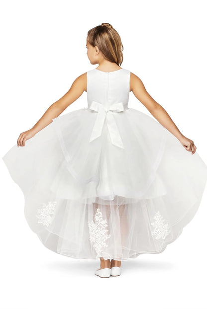 Young girl wearing a white floral dress on a white background