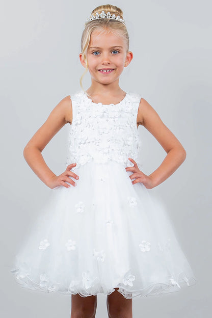 Young girl wearing a white floral dress with a tiara on a light gray background