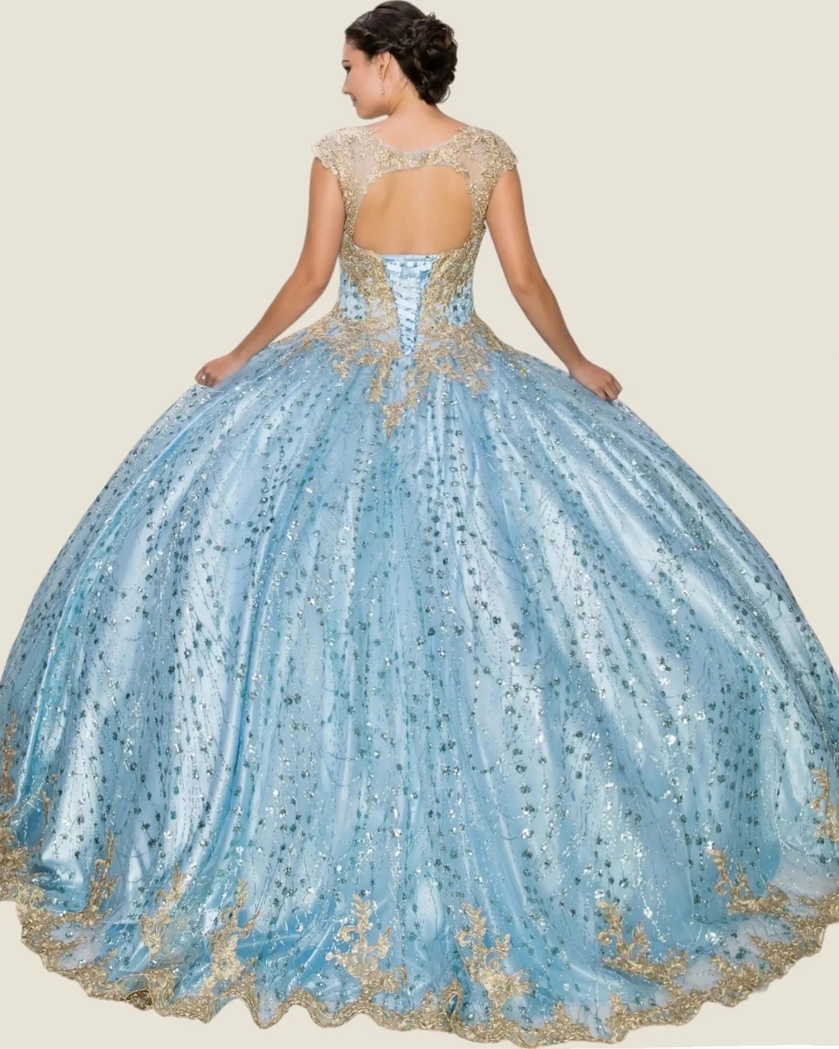 Blue and gold quinceanera dress with intricate detailing on a beige background