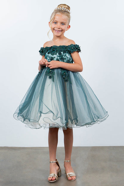 Young girl wearing a green off-shoulder dress with floral details against a white background