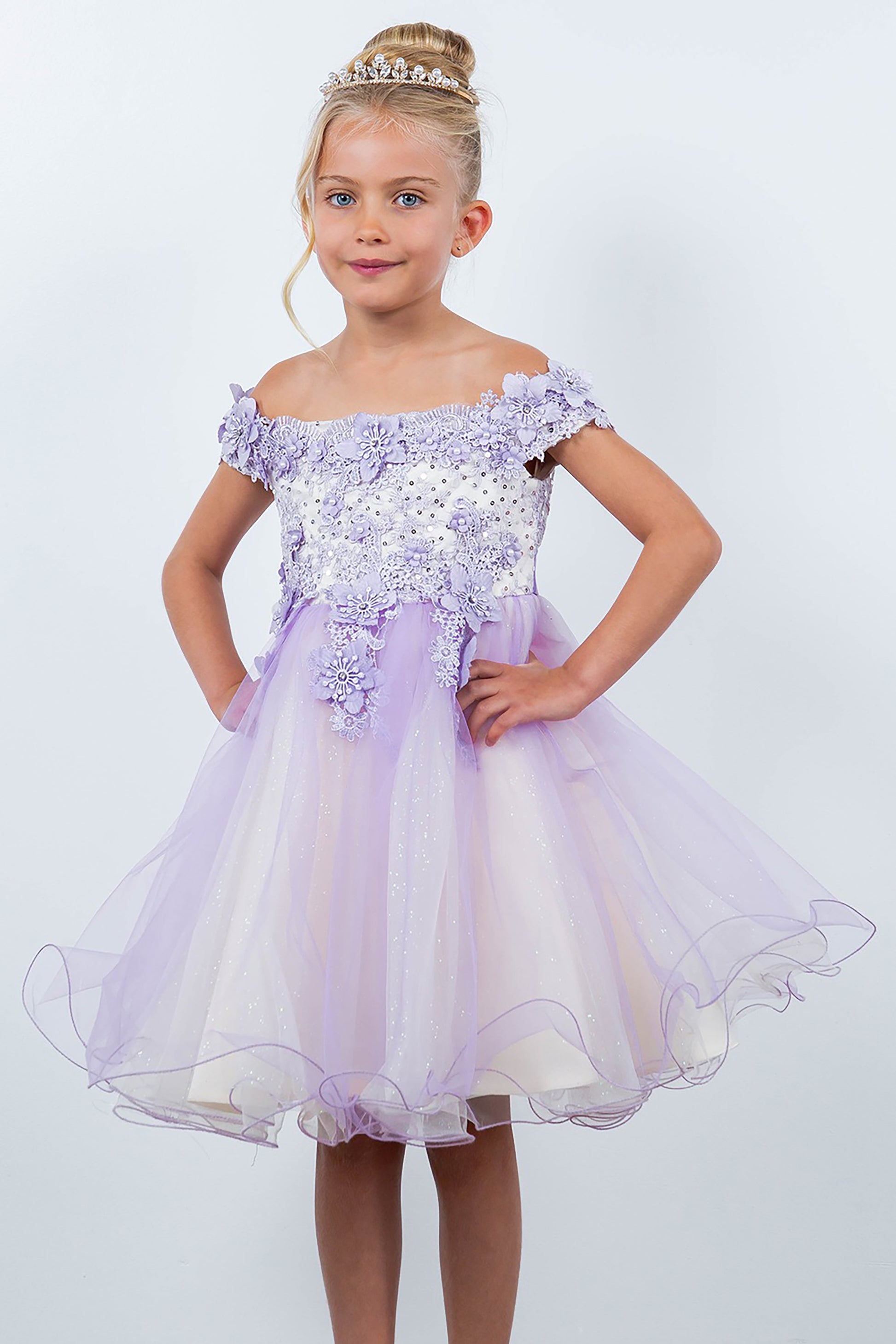 Young girl wearing a lilac off-shoulder dress with floral embellishments on a white background