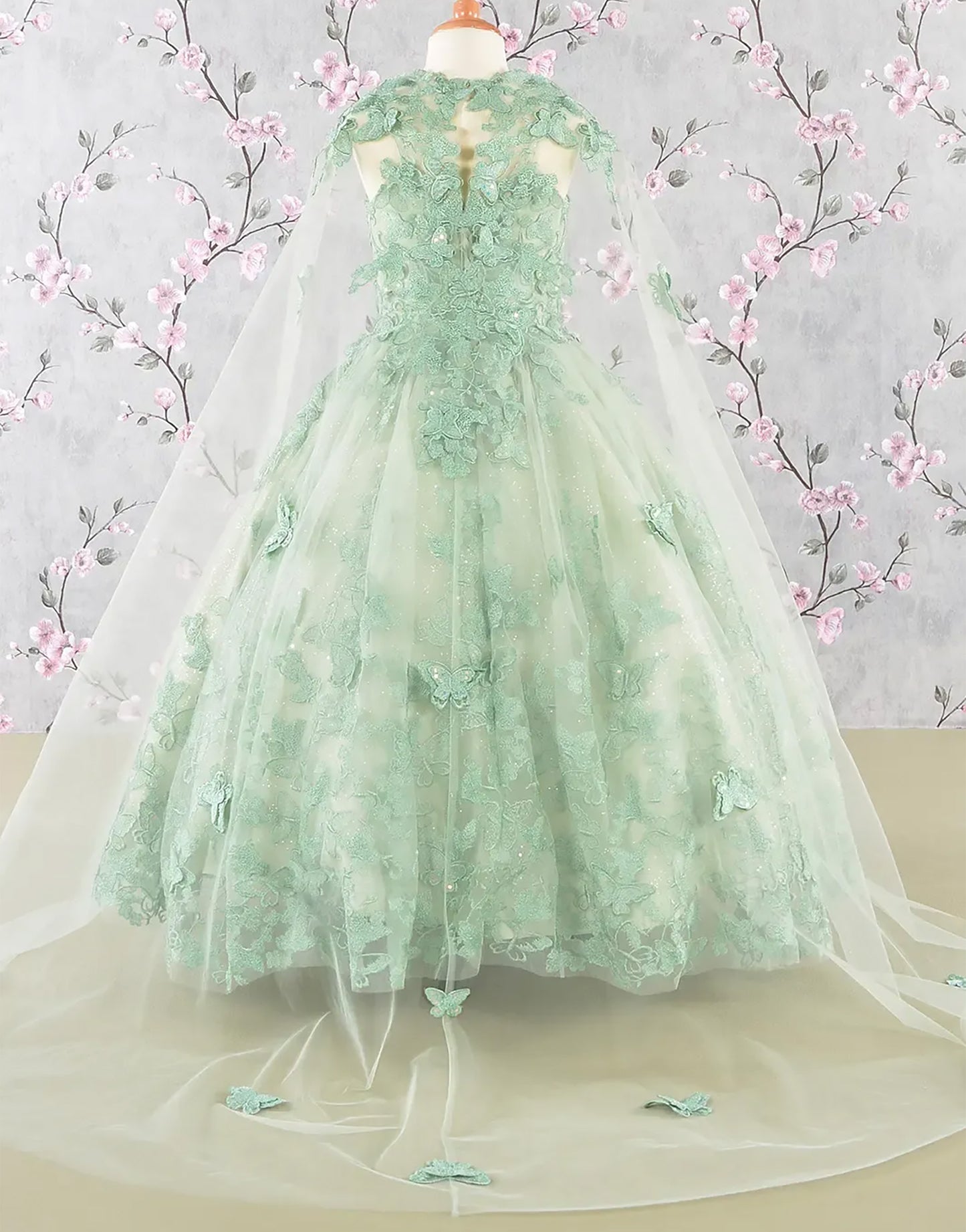 Green lace dress on a mannequin with floral background