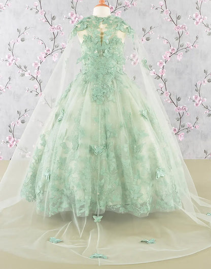 Green lace dress on a mannequin with floral background
