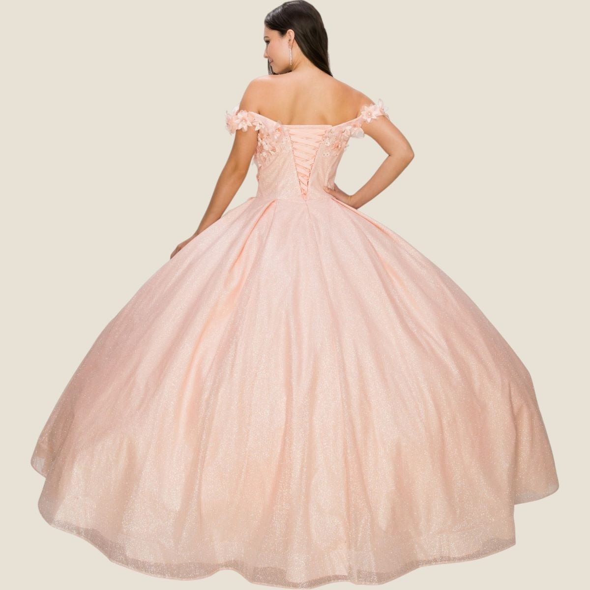 Woman wearing a pink off-shoulder gown on a beige background