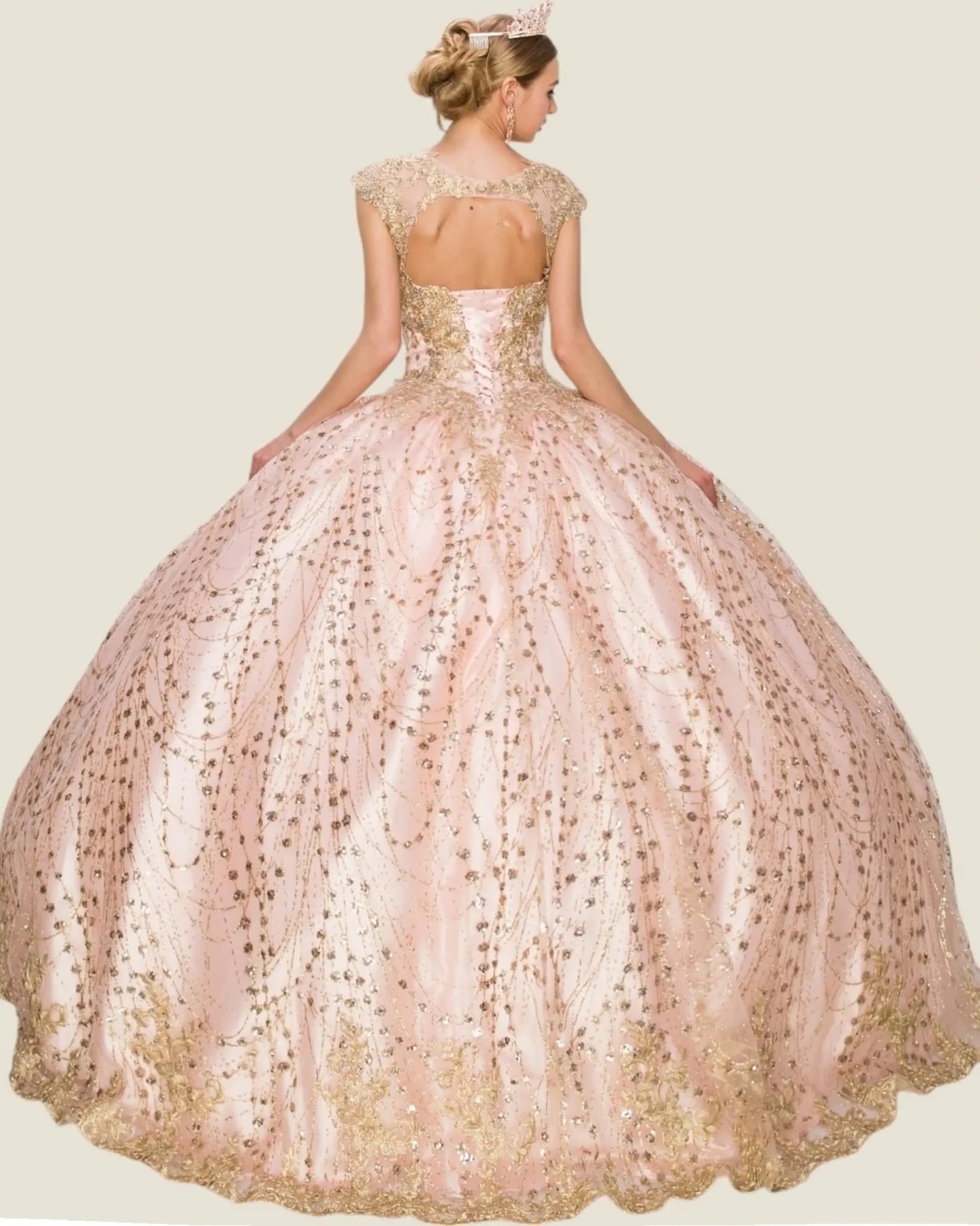Woman wearing a pink and gold ball gown with a plain background