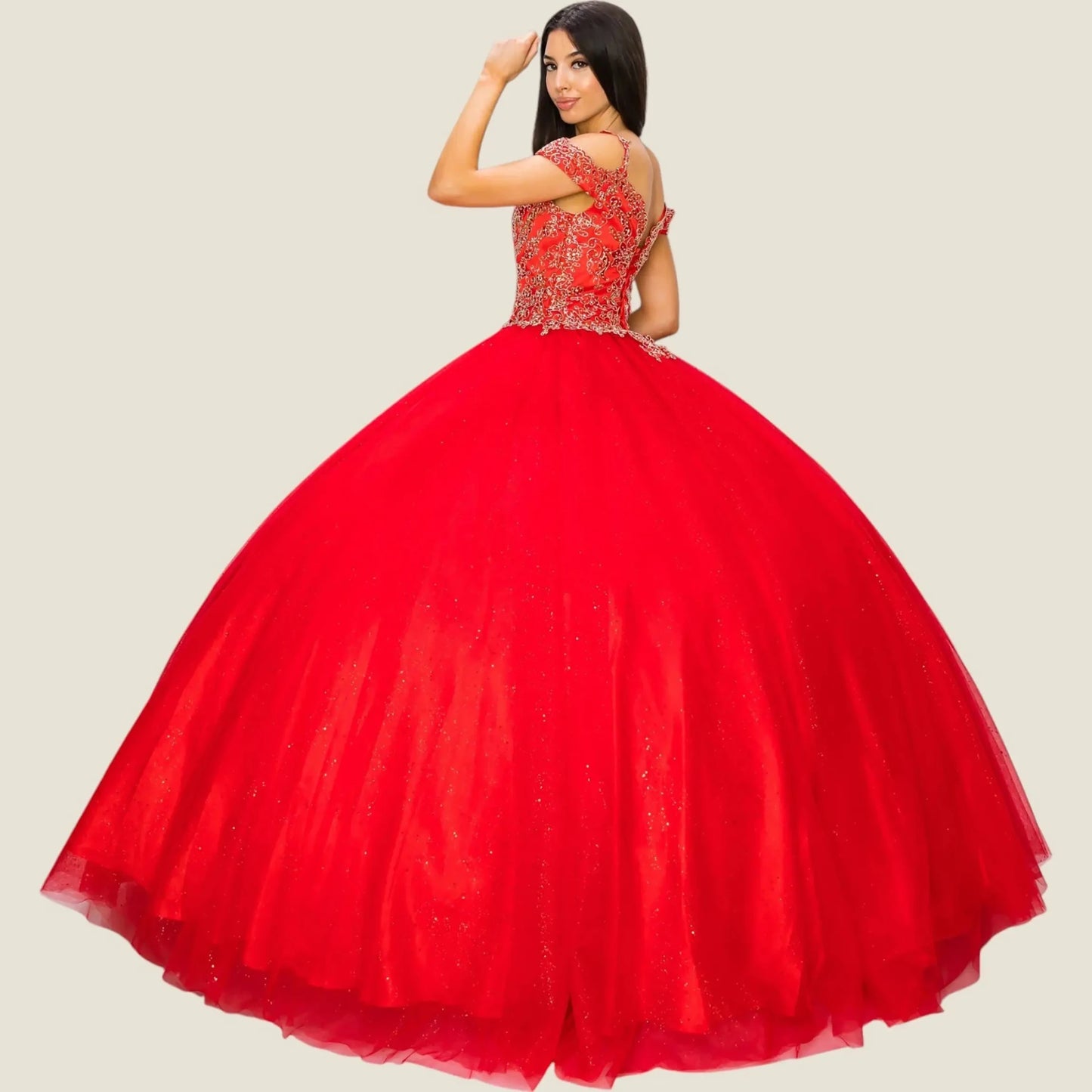 Red ball gown with intricate top design on a plain background