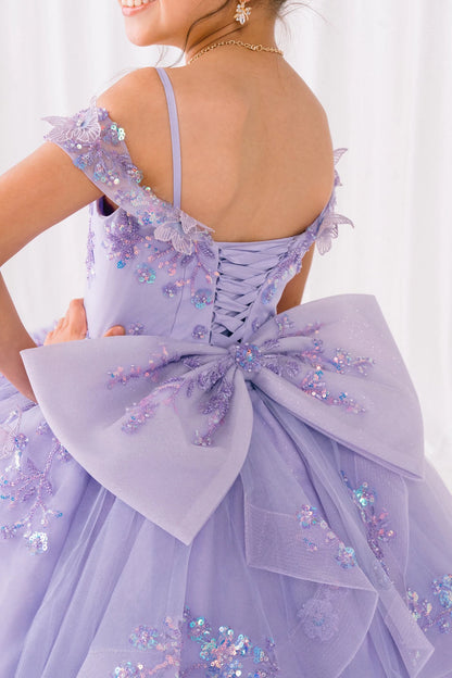 Lavender dress with floral embellishments and a large bow on a white background