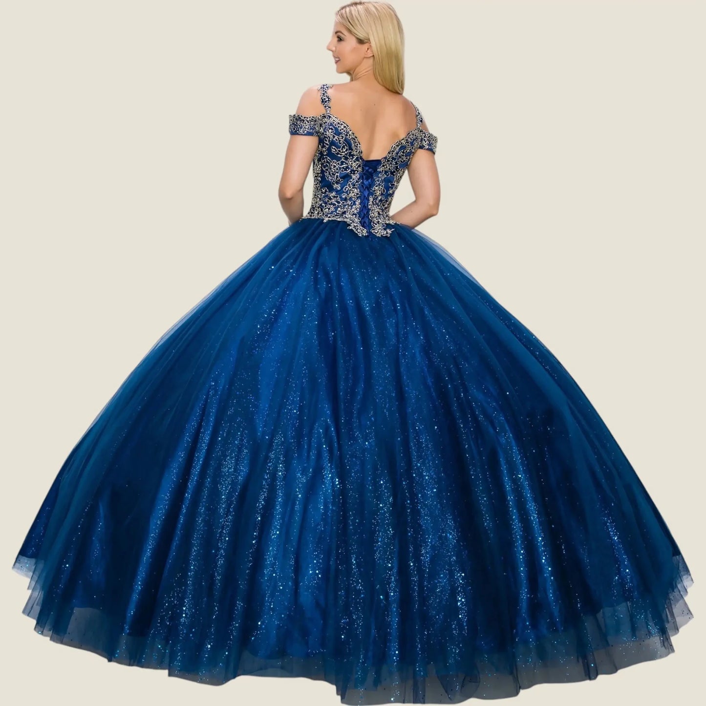Navy quince ball gown with intricate top on a beige background