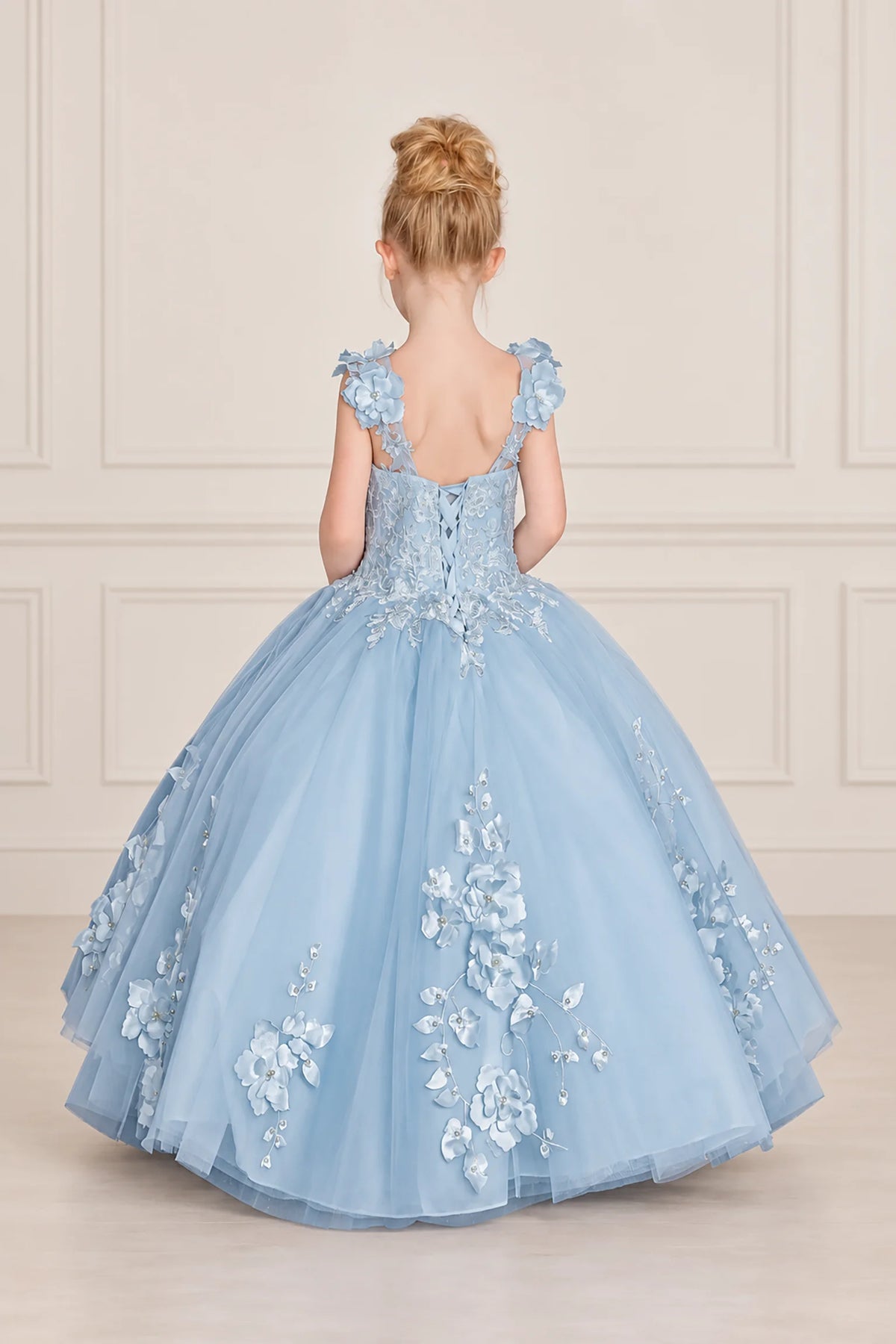Corset lacing and floral shoulder accents define the back of this Bahama Blue mini quinceañera dress.