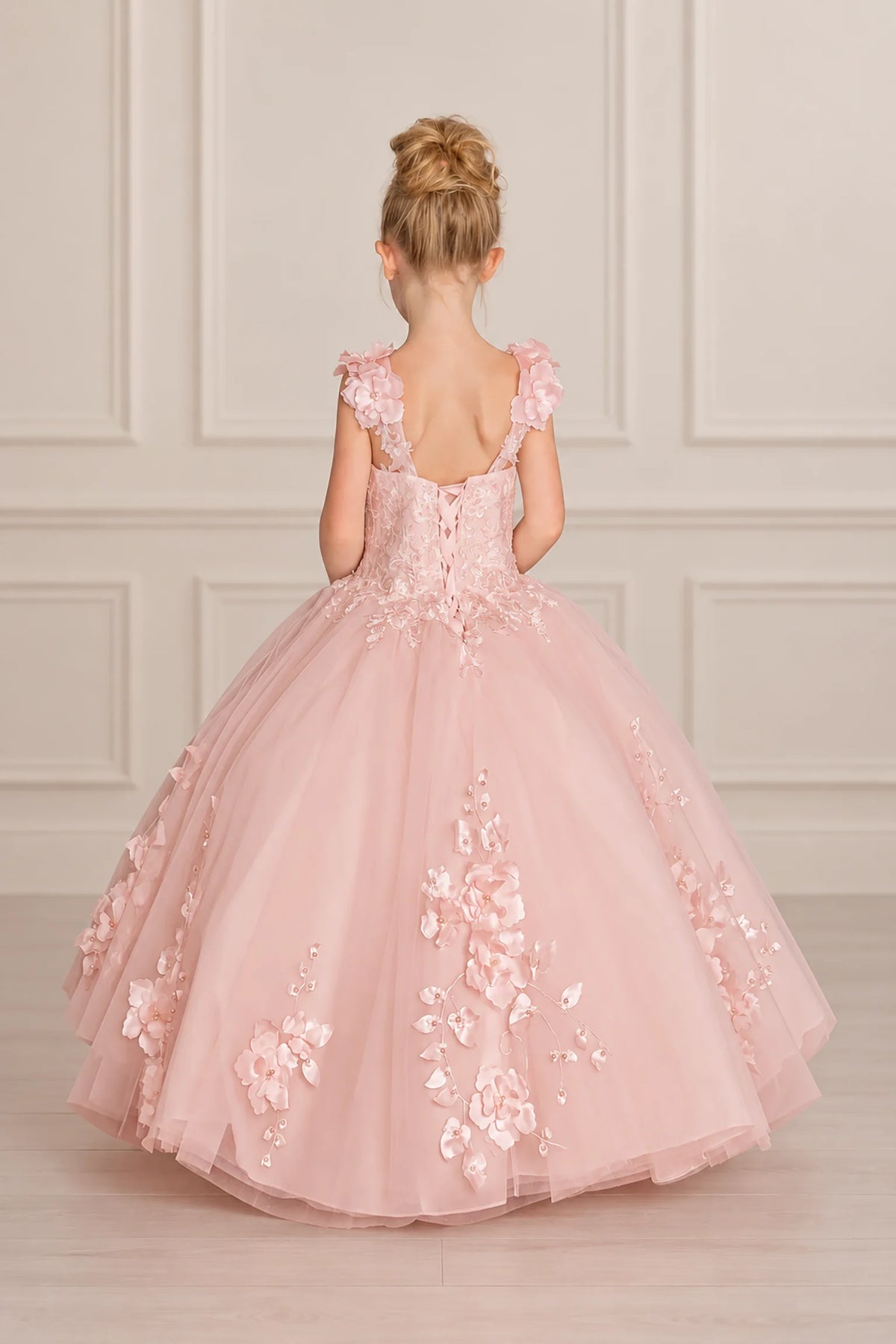 Corset lacing and floral shoulder accents define the back of this Blush mini quinceañera dress.