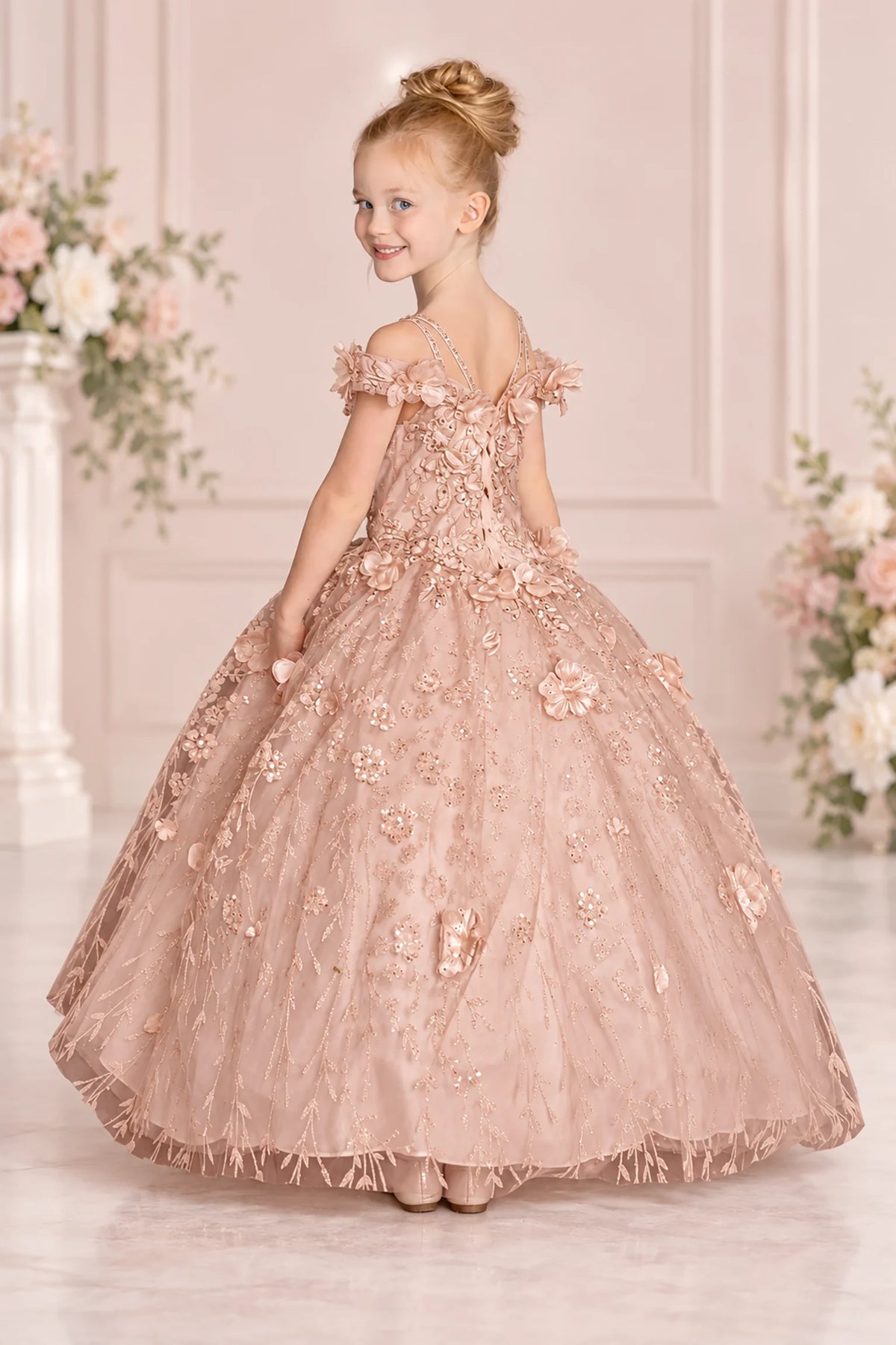 Embroidered vines and off-shoulder floral straps accent the Rose Gold mini quinceañera gown in this angled view.