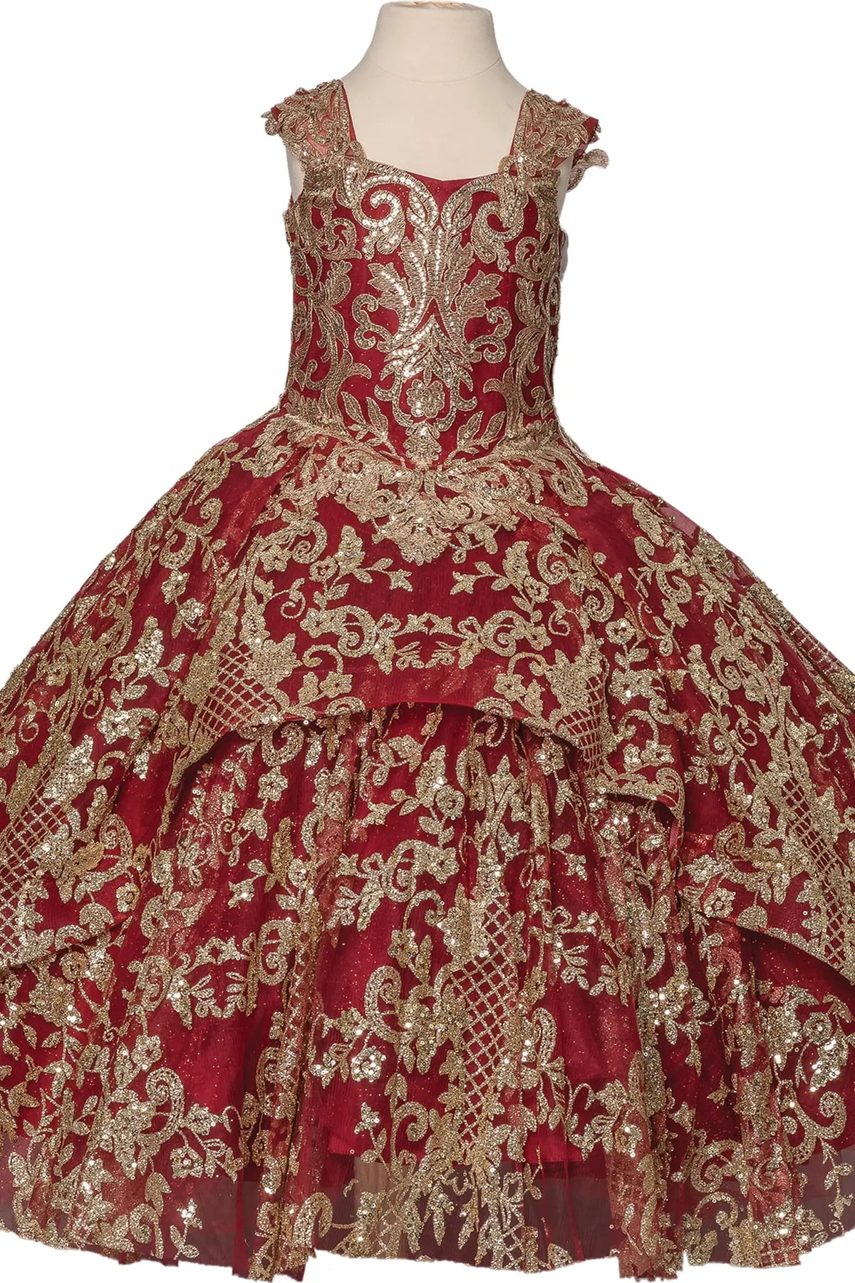 Framed by a full skirt, the Burgundy mini quinceañera dress shows gold scroll embroidery covering the bodice and layered burgundy skirt.