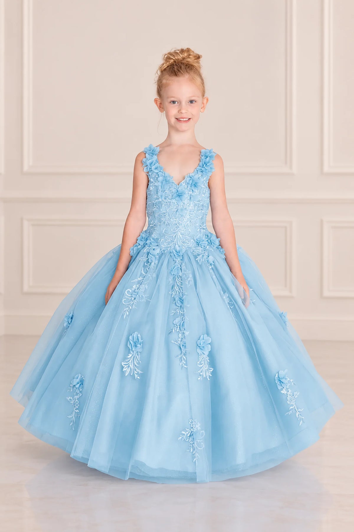 Double straps frame the embroidered V-neck bodice of this Bahama Blue mini quinceañera gown with floral tulle skirt.