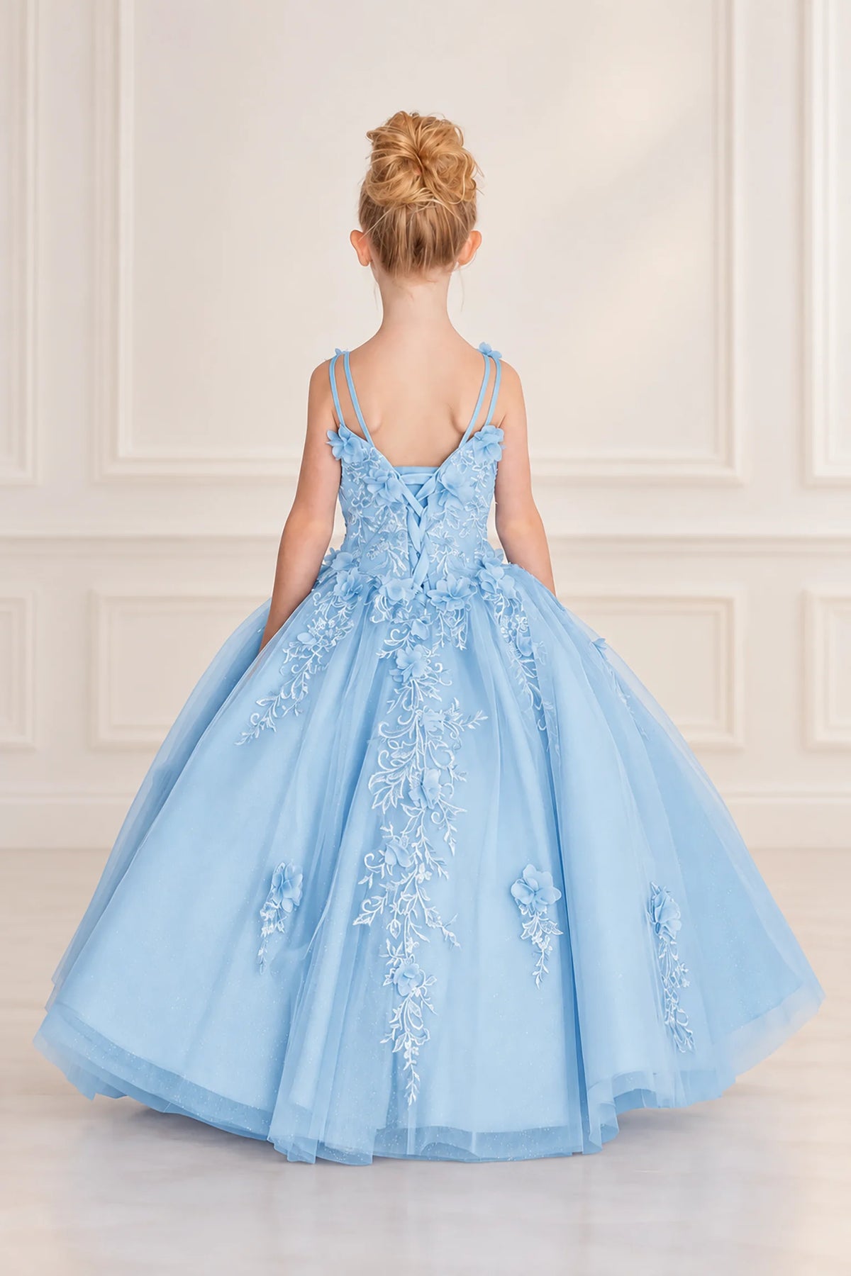 Lace-up detailing shapes the back of the Bahama Blue mini quinceañera dress beneath slender paired straps.