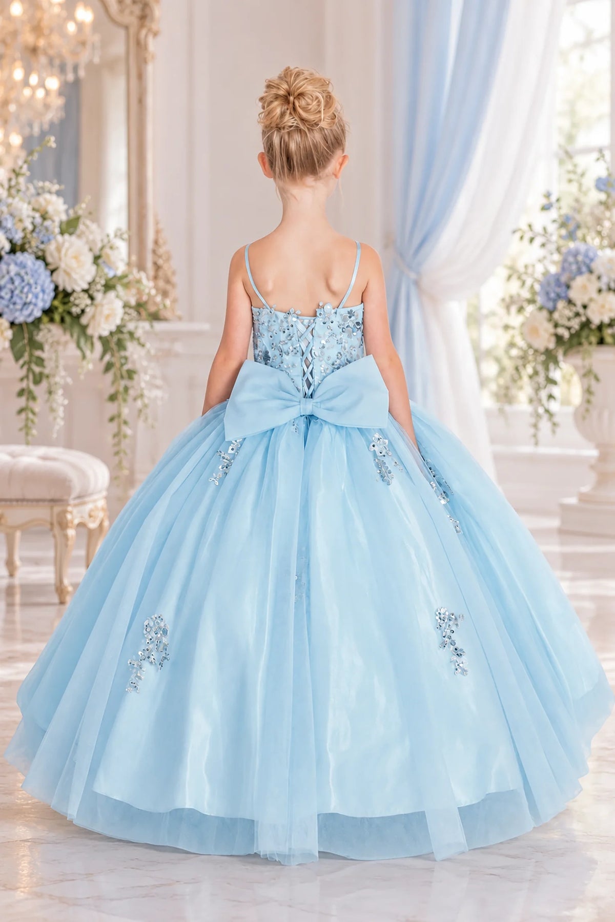 Behind the full skirt, the Bahama Blue mini quinceañera dress features oversized satin bow beneath a lace-up back.
