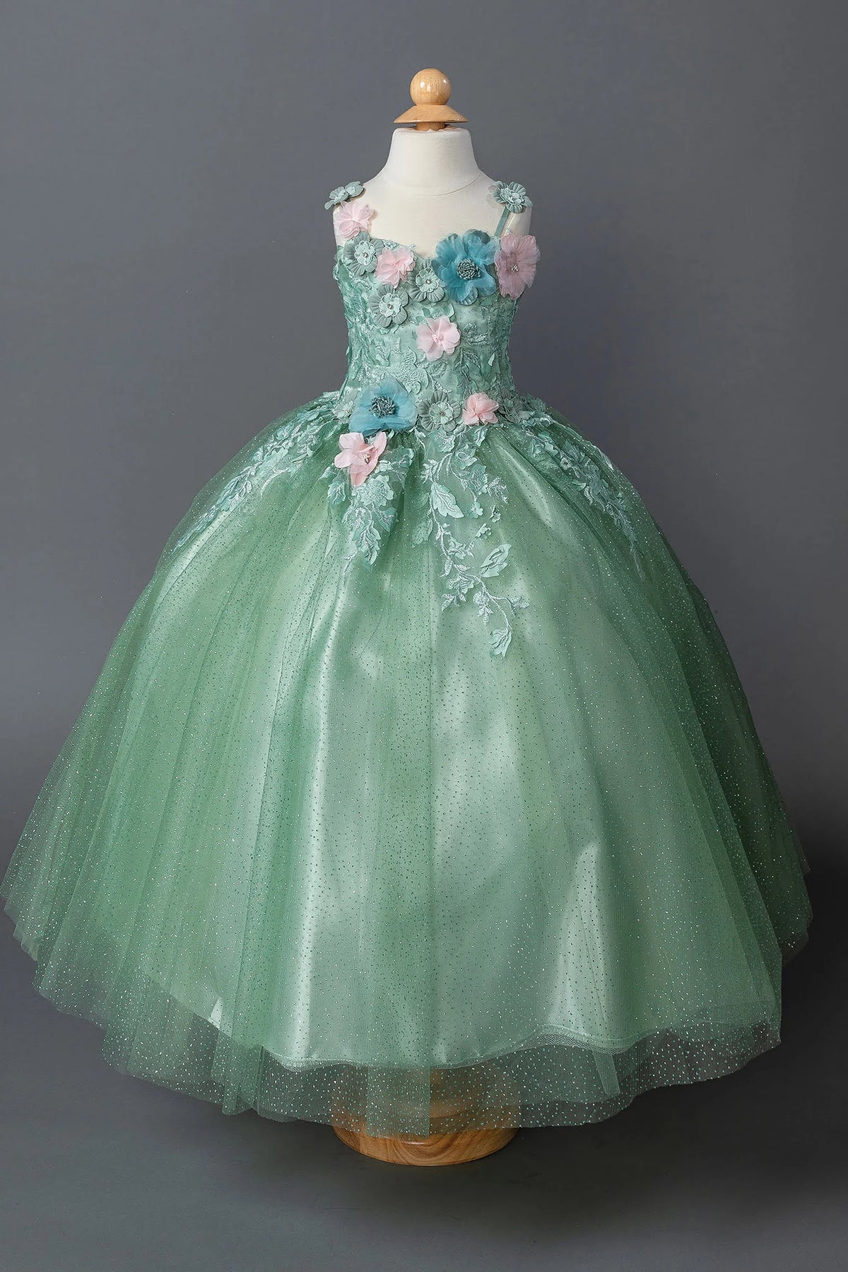 In full view, the Sage mini quinceañera dress shows multicolor blossoms climbing the fitted bodice and glitter skirt.