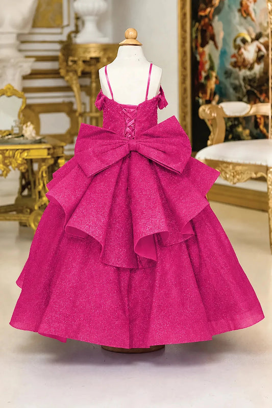An oversized tiered bow frames the lace-up back of the Fuchsia mini quinceañera dress.