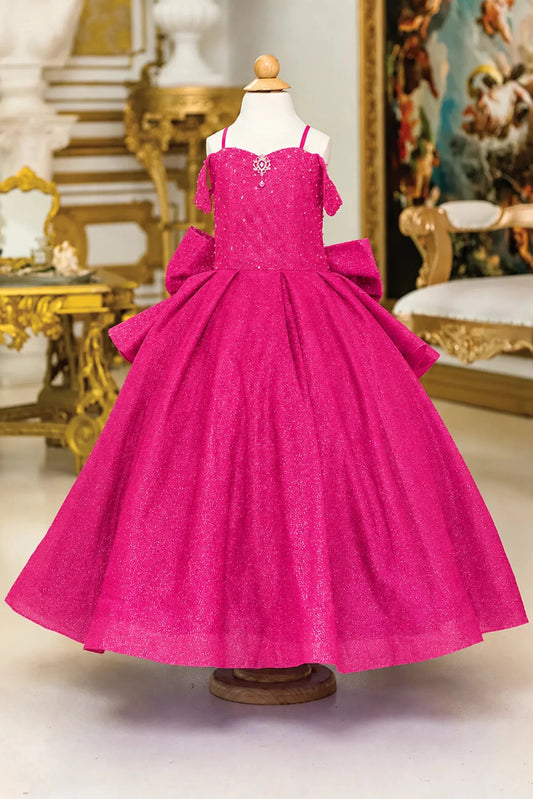 Glitter tulle forms the full skirt of this Fuchsia mini quinceañera gown beneath a fitted bodice with delicate straps.