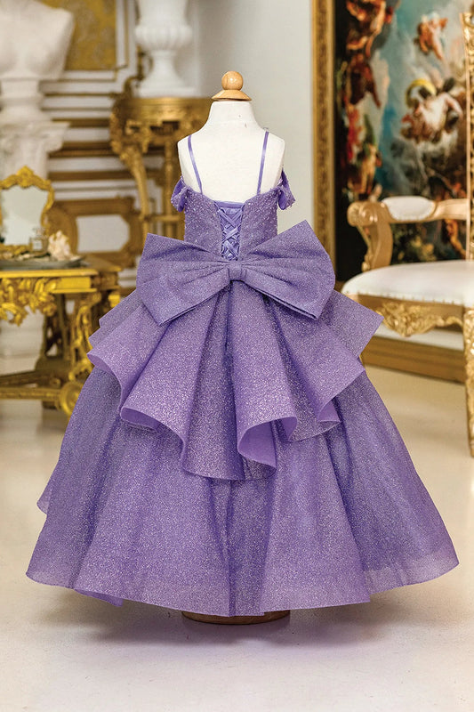 At first glance, the Lilac mini quinceañera dress shows soft glitter tulle flowing from the fitted bodice.