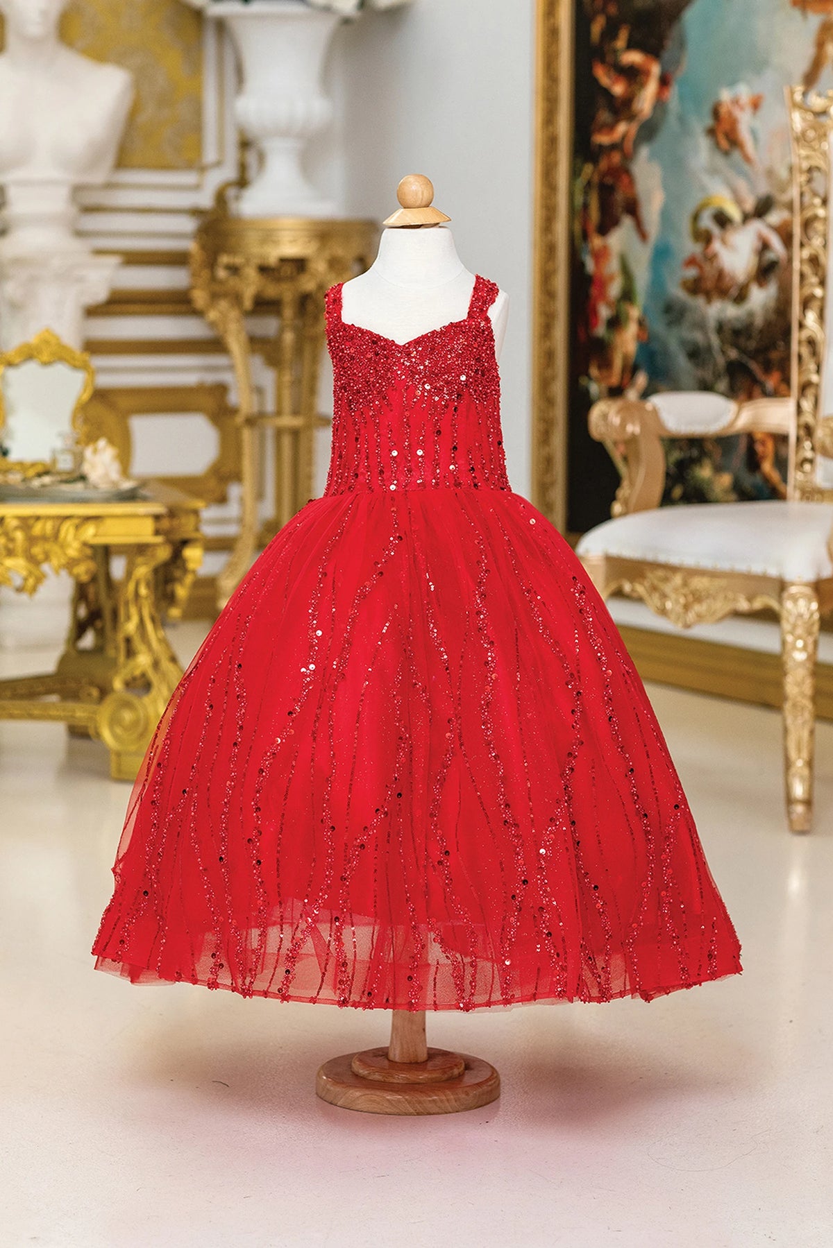 Framed by a full skirt, the Red mini quinceañera dress shows beading and vertical sequin trails across the full silhouette.