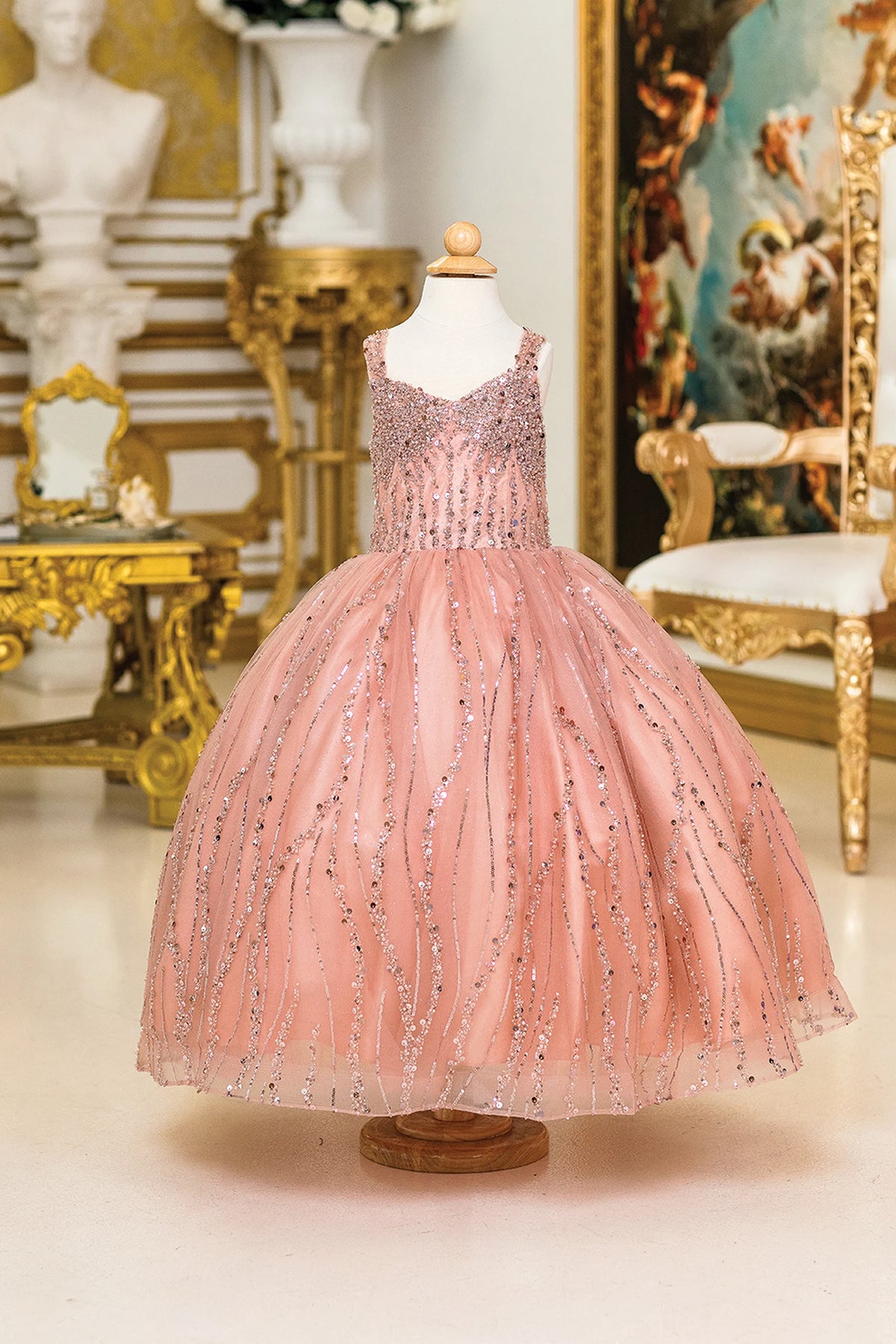 Detailed through the bodice, the Rose Gold mini quinceañera dress shows beading and vertical sequin trails across the full silhouette.