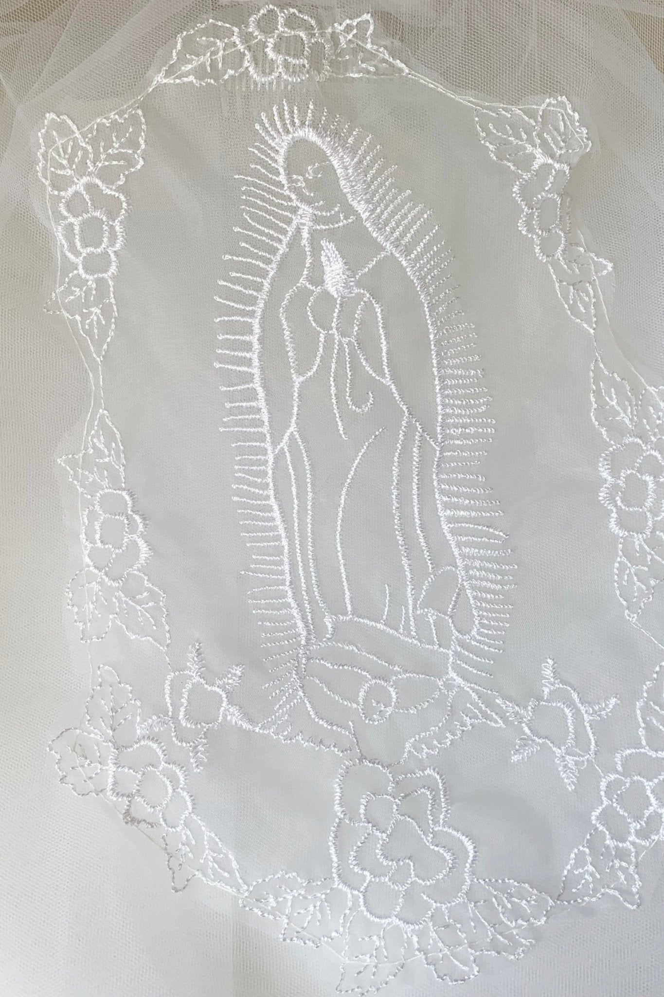 White Virgin Mary embroidered first communion veil, close-up.