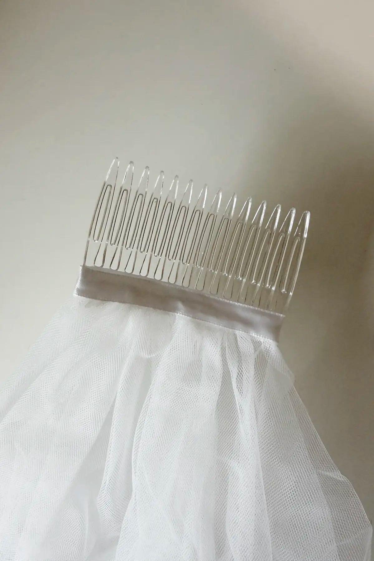 White tulle Virgin Mary embroidered first communion veil.