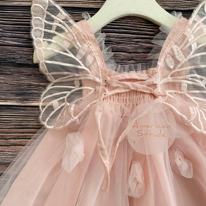 Intricate features stand out across Blush fairy flower girl dress with butterfly wings.
