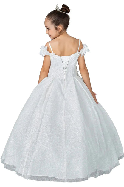 Young girl standing back-facing in white kids mini quinceañera dress with lace-up bodice, floral shoulder appliqués, and glitter tulle skirt