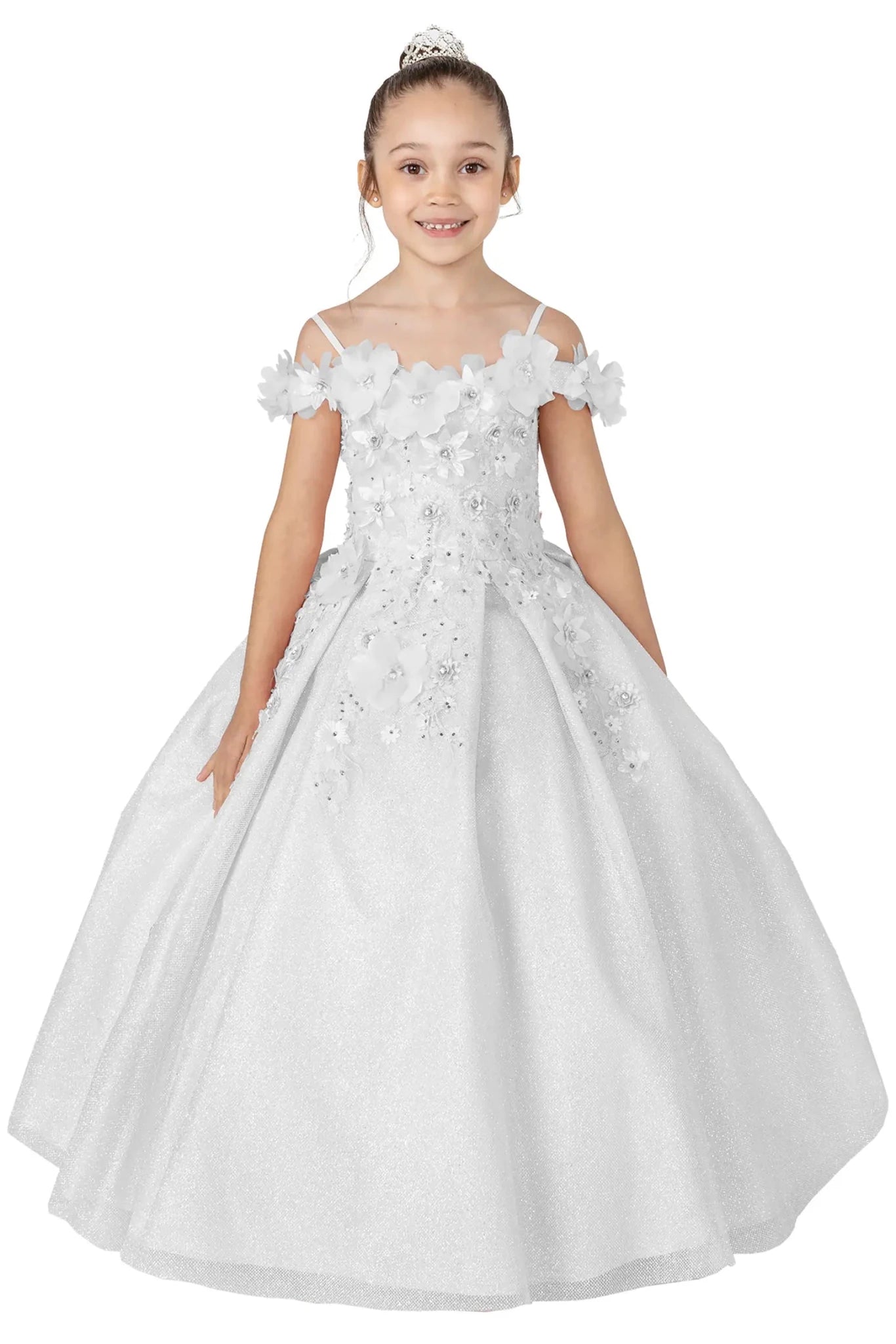 Young girl standing front-facing in white kids mini quinceañera dress with floral shoulder appliqués and glitter tulle layered skirt