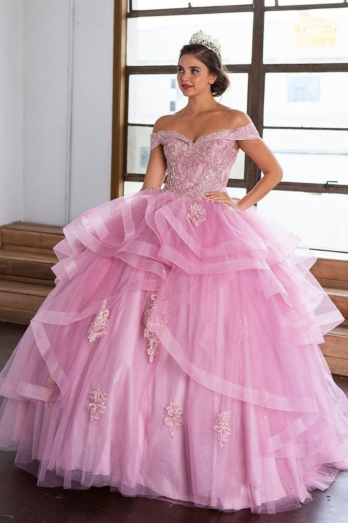Mauve Rose quinceañera ball gown with an embroidered off-shoulder bodice and tiered ruffle skirt.