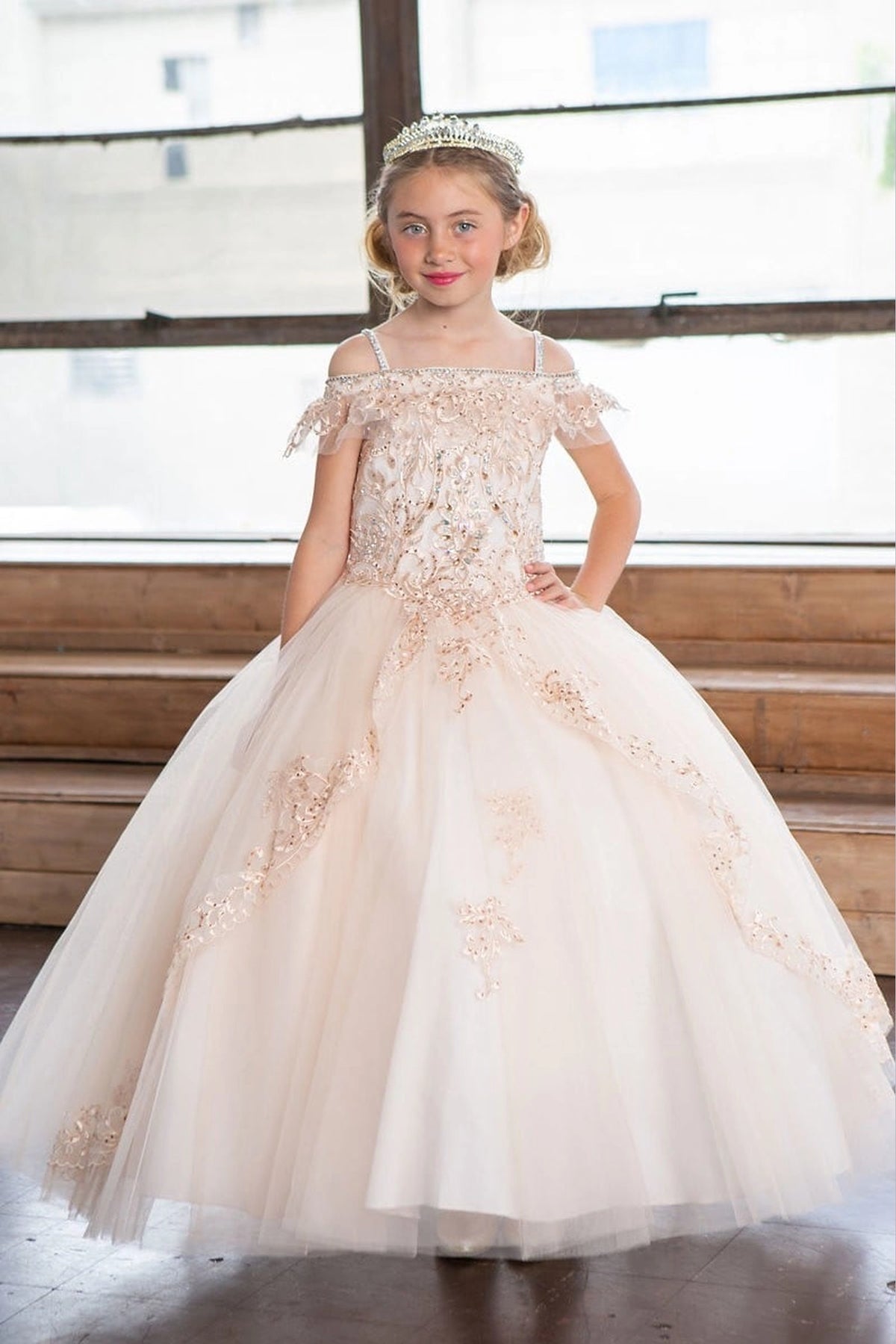 In full view, the Champagne mini quince dress showcases off-the-shoulder embroidered bodice and delicately embroidered tulle skirt.