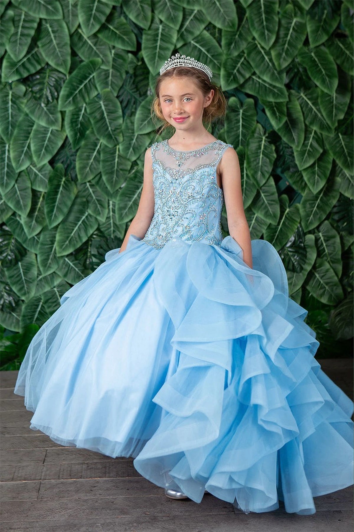 Seen at full length, the Bahama Blue mini quince dress showcases crystal-embellished sleeveless bodice and cascading layered ruffle skirt.