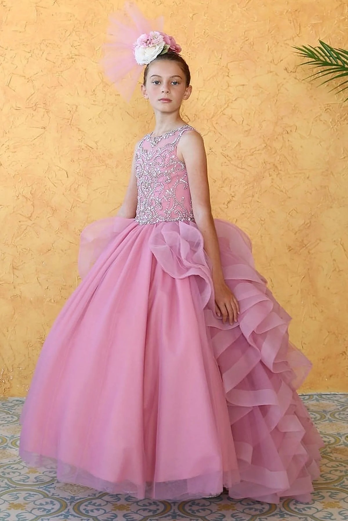 This second view emphasizes cascading layered ruffle skirt on the Dusty Pink mini quince dress.