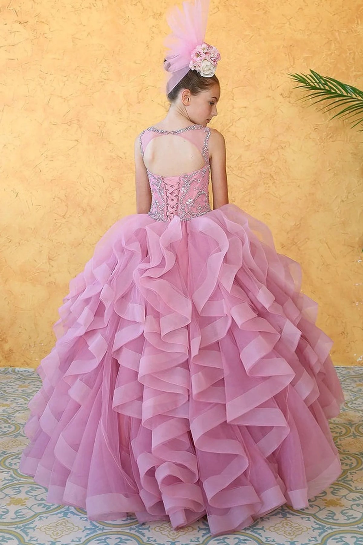 A closer crop highlights cascading layered ruffle skirt on the Dusty Pink mini quince dress.