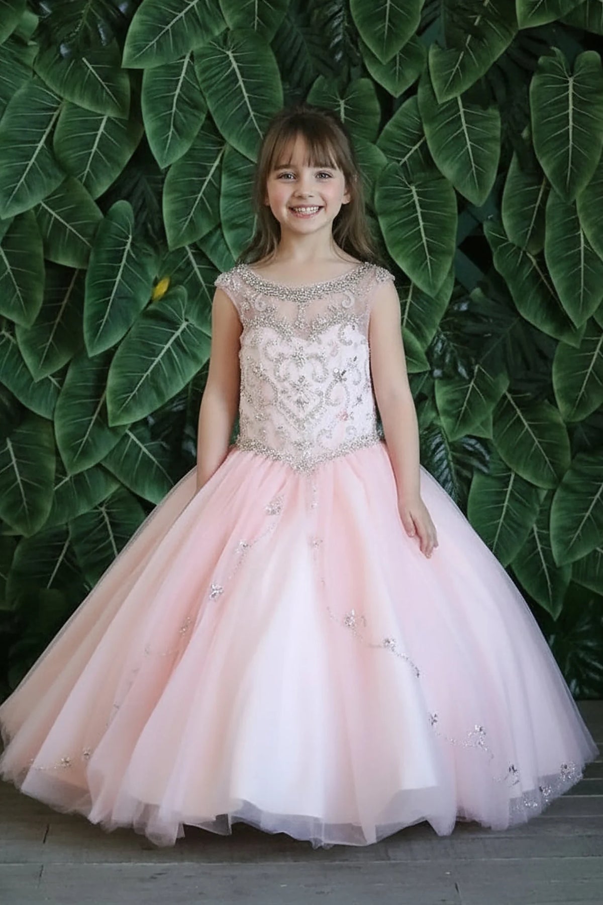 Delicate accents highlight, the Blush Pink mini quince dress showcases floral embroidered fitted bodice and full tulle ball gown skirt with appliqué accents.