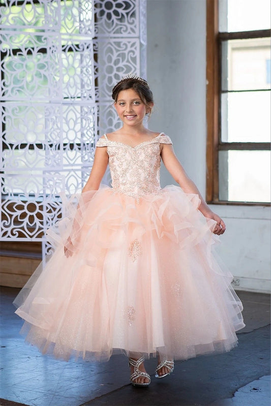 Across the silhouette, the Blush Pink mini quince dress showcases sparkling jeweled fitted bodice and layered formal skirt with dimensional tiers.