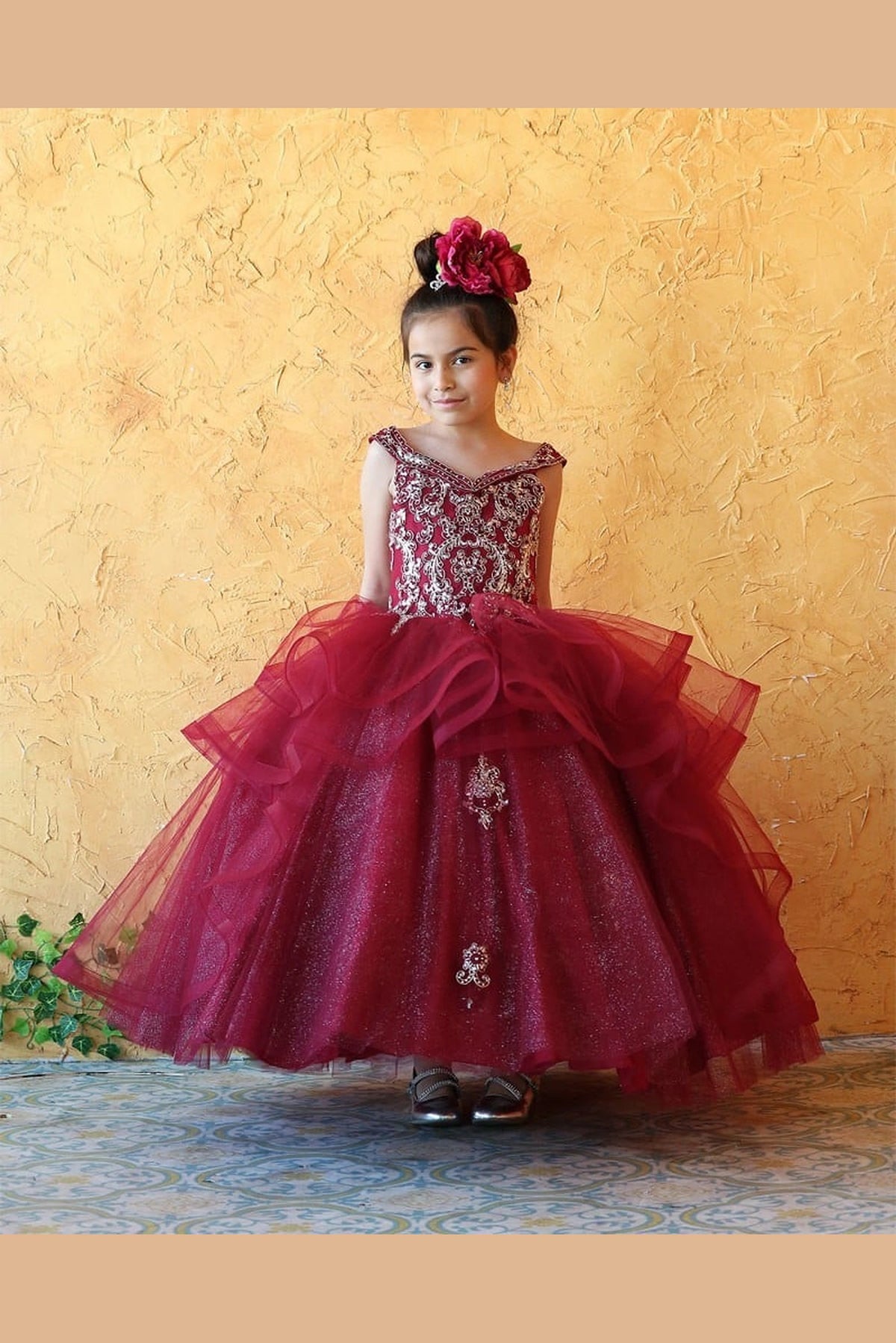 From the neckline down, the Burgundy mini quince dress showcases sparkling jeweled fitted bodice and layered formal skirt with dimensional tiers.
