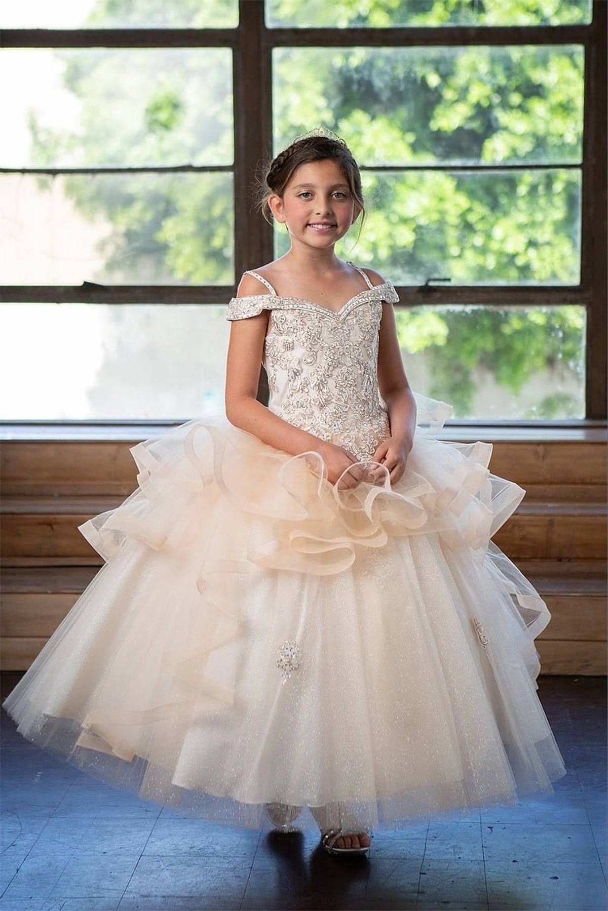 A graceful front view, the Champagne mini quince dress showcases sparkling jeweled fitted bodice and layered formal skirt with dimensional tiers.