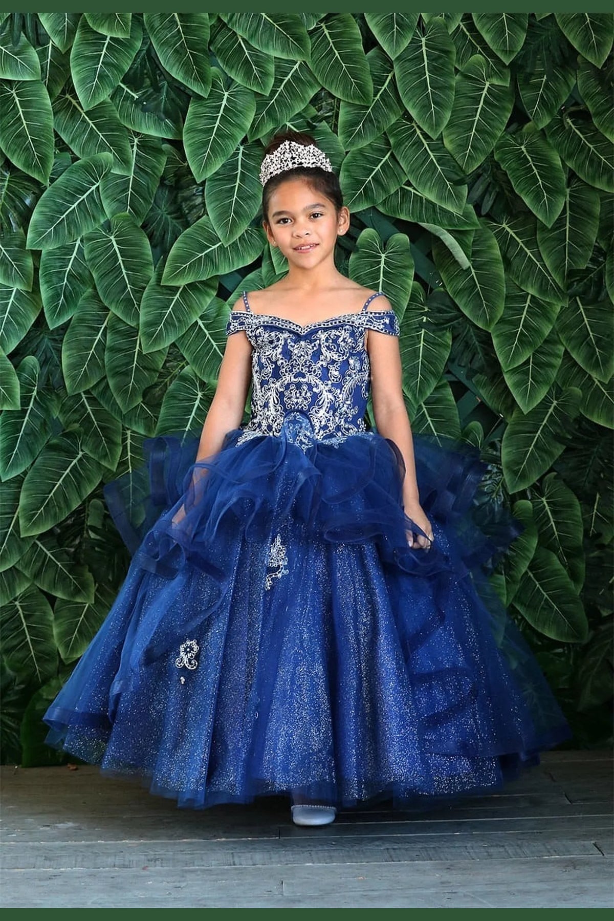 The dress profile reveals, the Navy mini quince dress showcases sparkling jeweled fitted bodice and layered formal skirt with dimensional tiers.