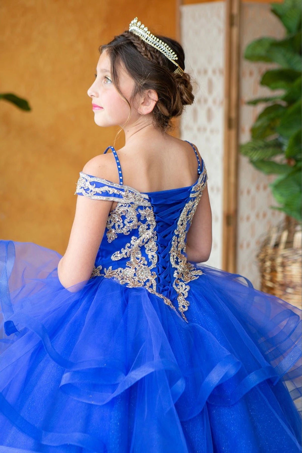 Behind the full skirt, the Royal Blue mini quince dress displays its lace-up finish and layered formal skirt with dimensional tiers.
