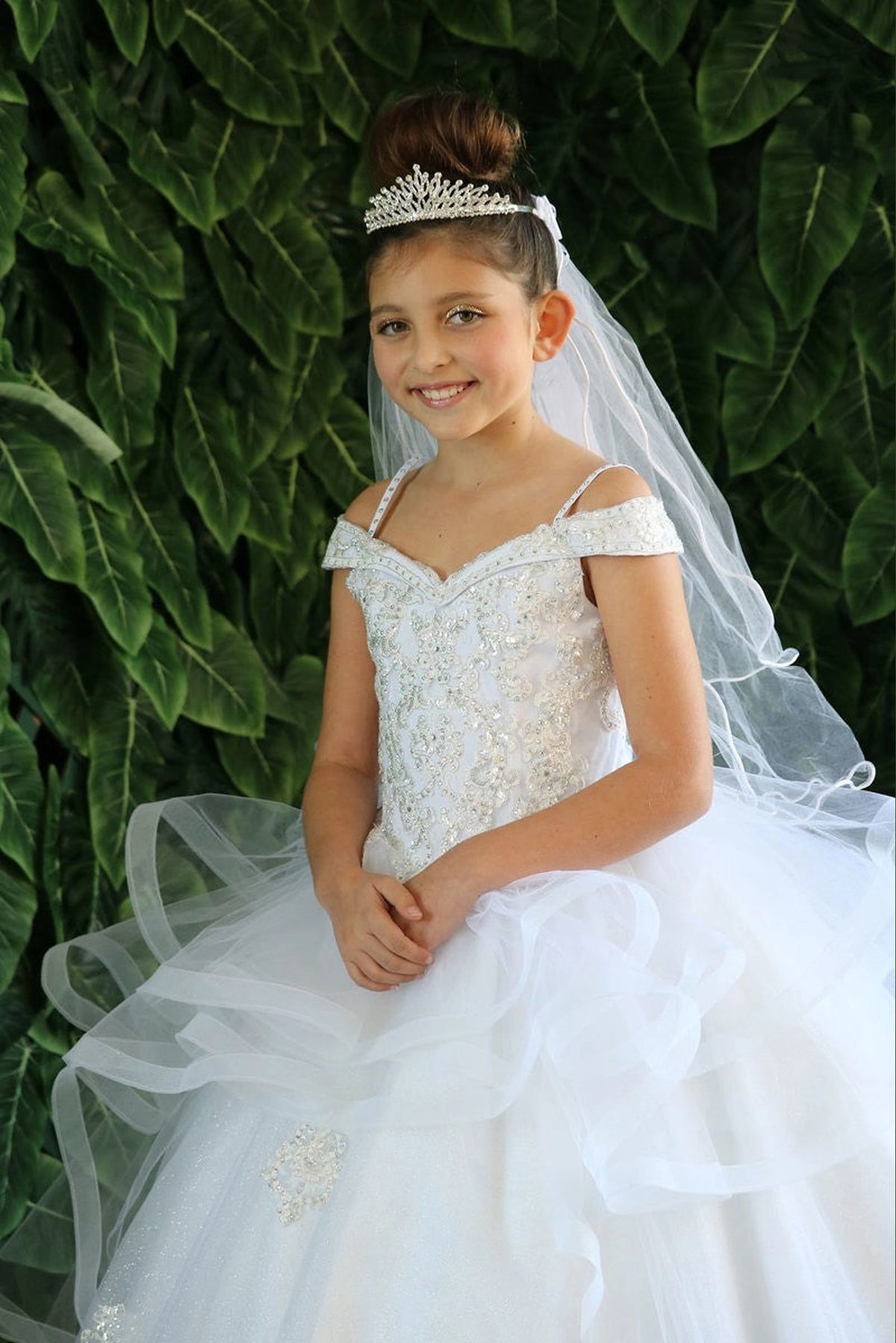 This second view emphasizes the sparkling jeweled fitted bodice on the White mini quince dress.