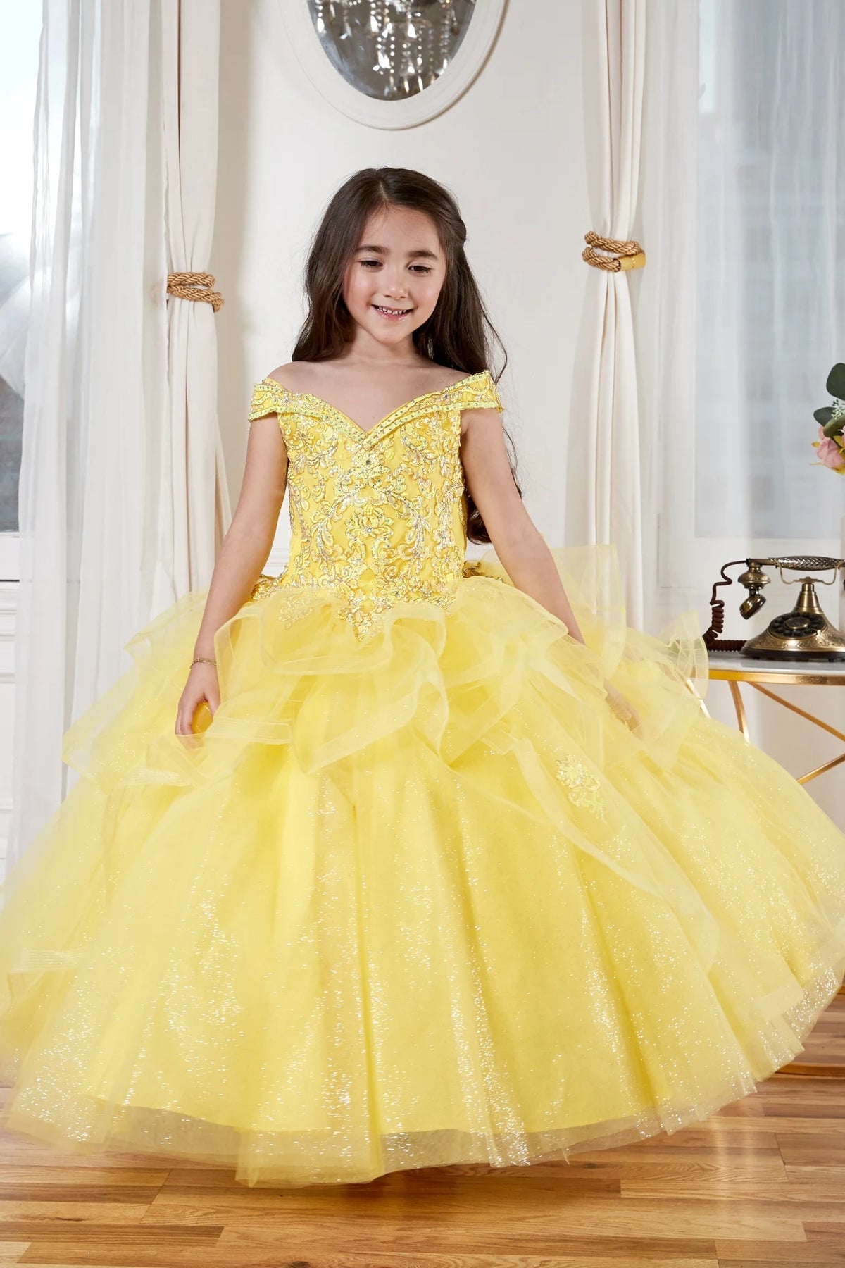 From the neckline down, the Yellow mini quince dress showcases sparkling jeweled fitted bodice and layered formal skirt with dimensional tiers.