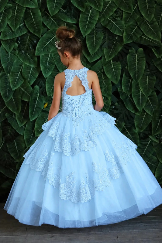 Turning to the back, the Bahama Blue mini quince dress displays its lace-up finish and full layered tulle skirt with ruffle tiers.