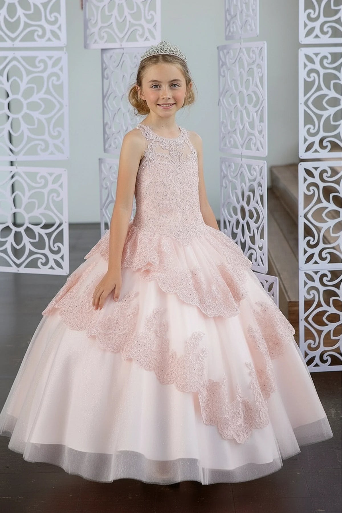 Behind the full skirt, the Blush mini quince dress displays its lace-up finish and full layered tulle skirt with ruffle tiers.