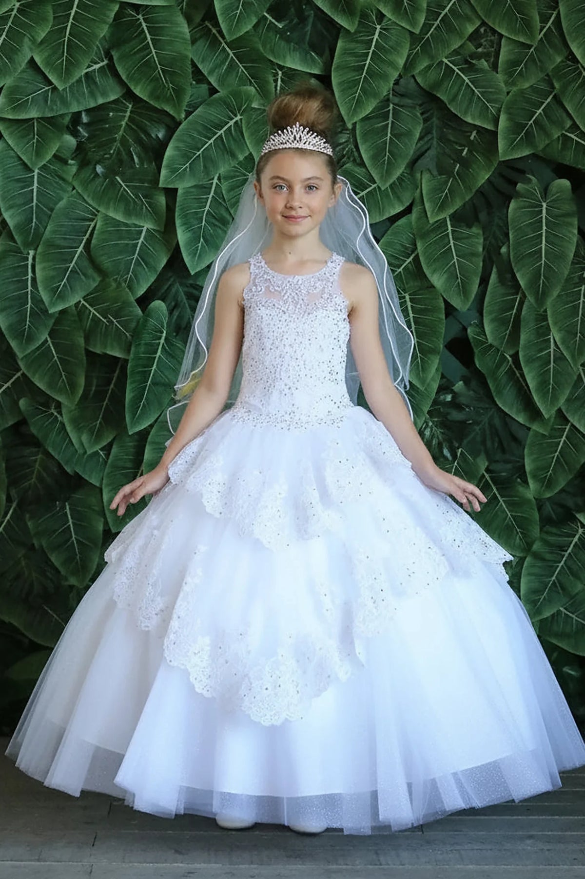 Along the back, the White mini quince dress displays its lace-up finish and full layered tulle skirt with ruffle tiers.