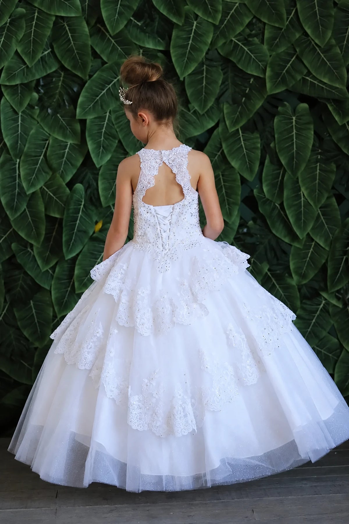 A closer crop highlights full layered tulle skirt with ruffle tiers on the White mini quince dress.