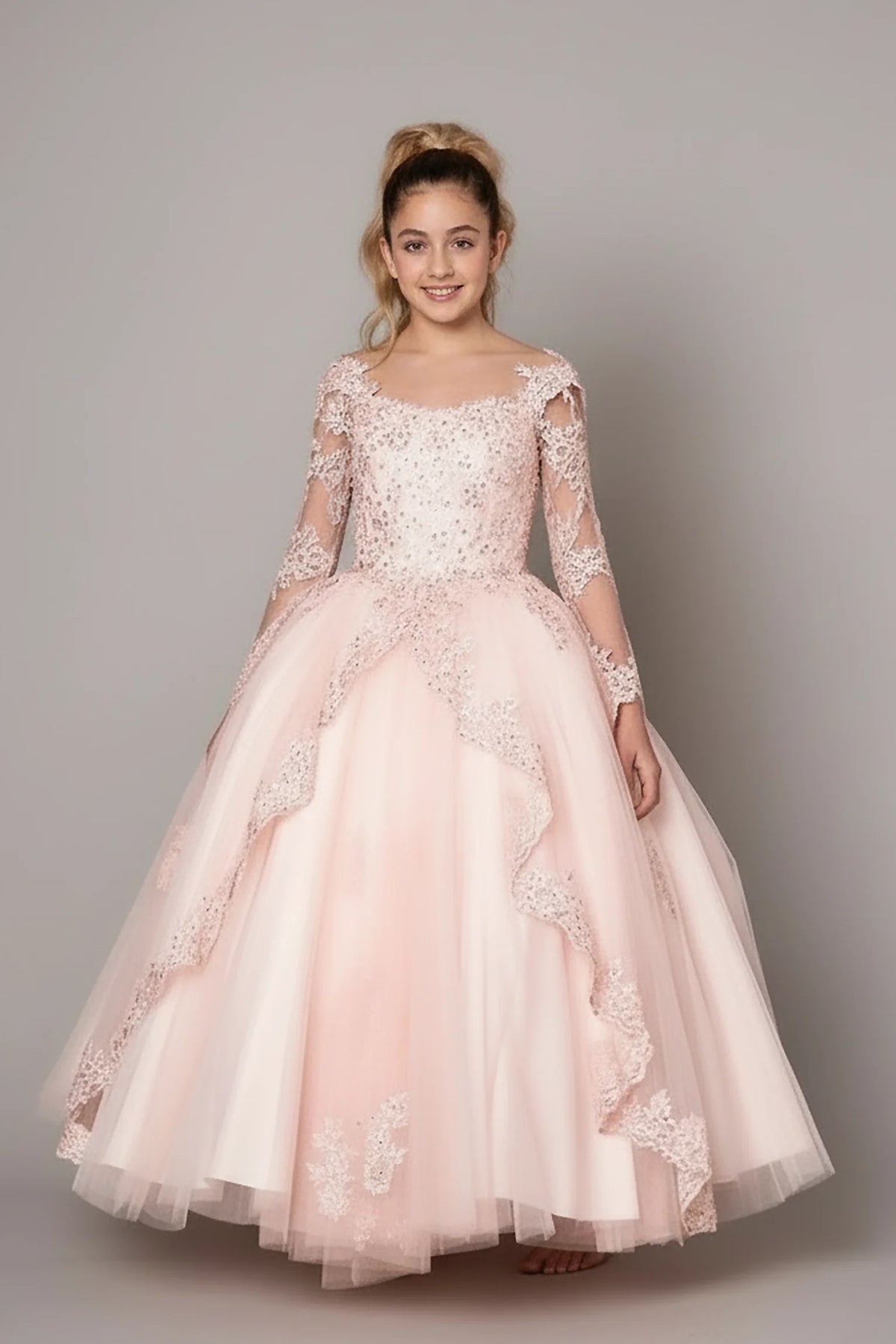 A graceful front view, the Blush mini quince dress showcases floral lace bodice with sheer long sleeves and full embroidered tulle ball gown skirt.