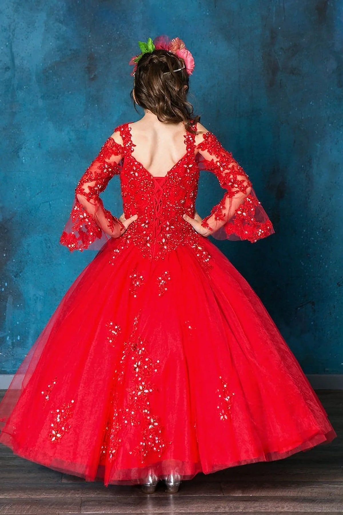 From behind, the Red mini quince dress displays its lace-up finish and full embroidered tulle ball gown skirt.
